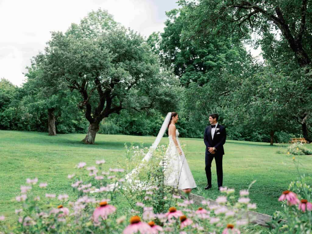 Bride and groom at outdoor wedding in Vermont's scenic garden.