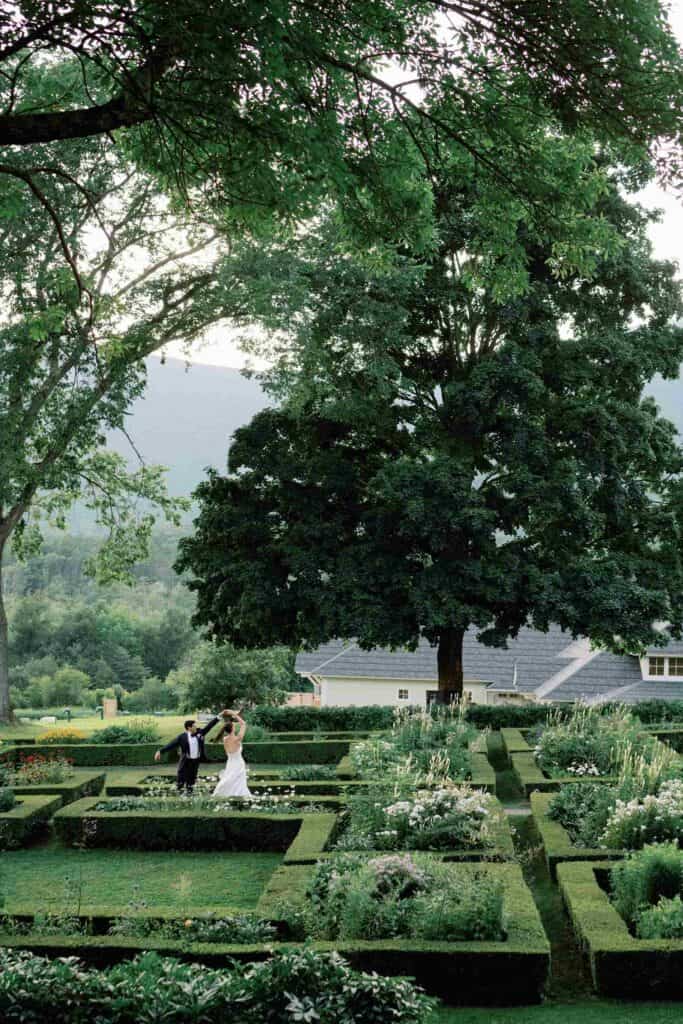 Couple dancing in lush garden at Hildene for wedding.