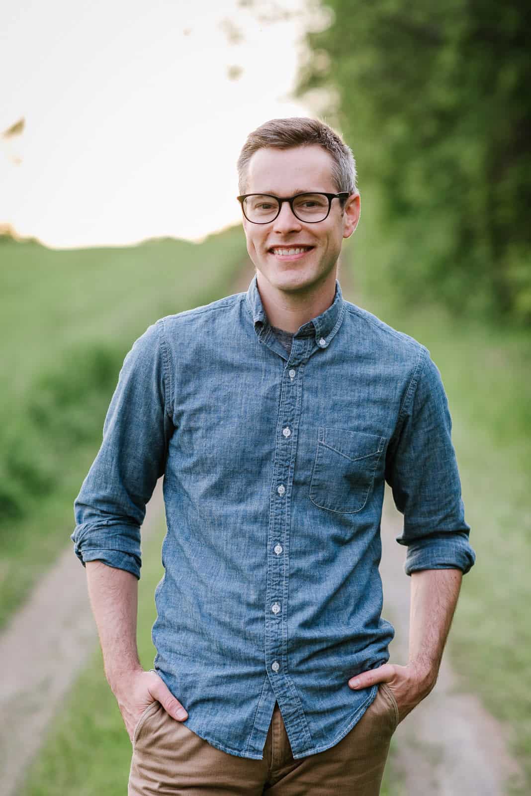 Smiling man in denim shirt outdoors, Vermont wedding professional.