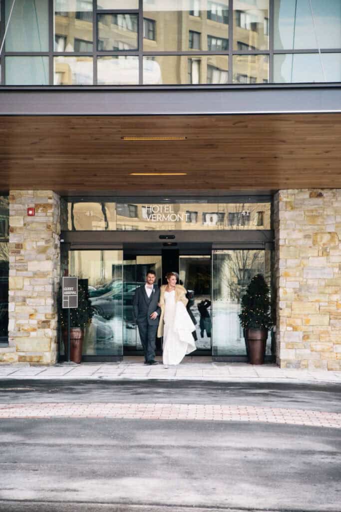Bride and groom exiting Hotel Vermont after wedding ceremony.