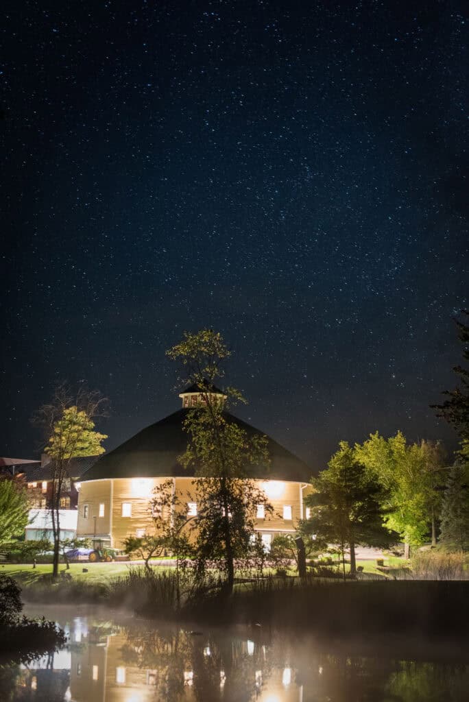 Night view of Vermont wedding venue with starry sky and illuminated building.