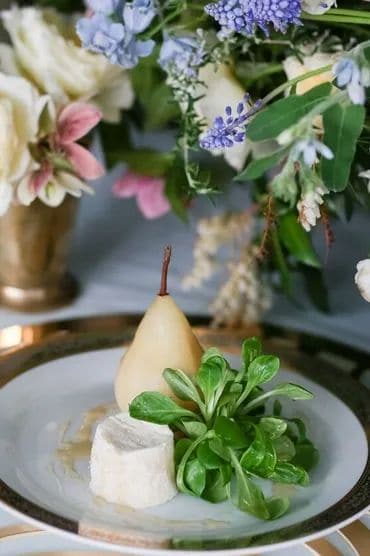 Cheese and herb platter with flowers for wedding event decor.