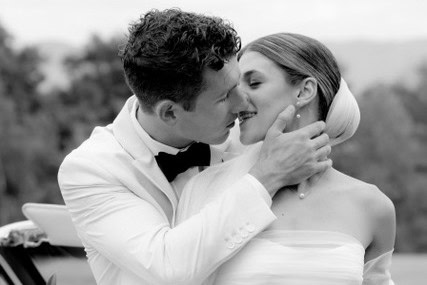 Happy bride and groom sharing a kiss at Vermont wedding event.