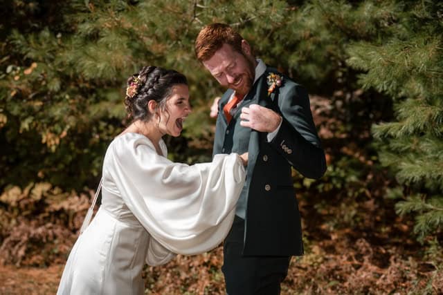 Bride and groom sharing a joyful moment outdoors in Vermont.