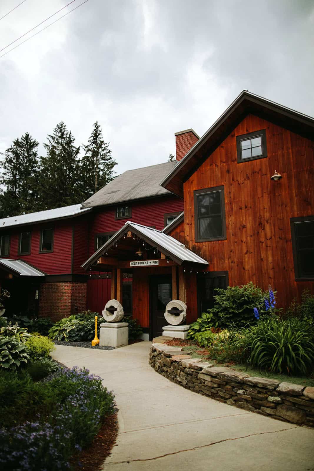 Vermont wedding venue at Mad River Barn with rustic architecture and lush garden surroundings.