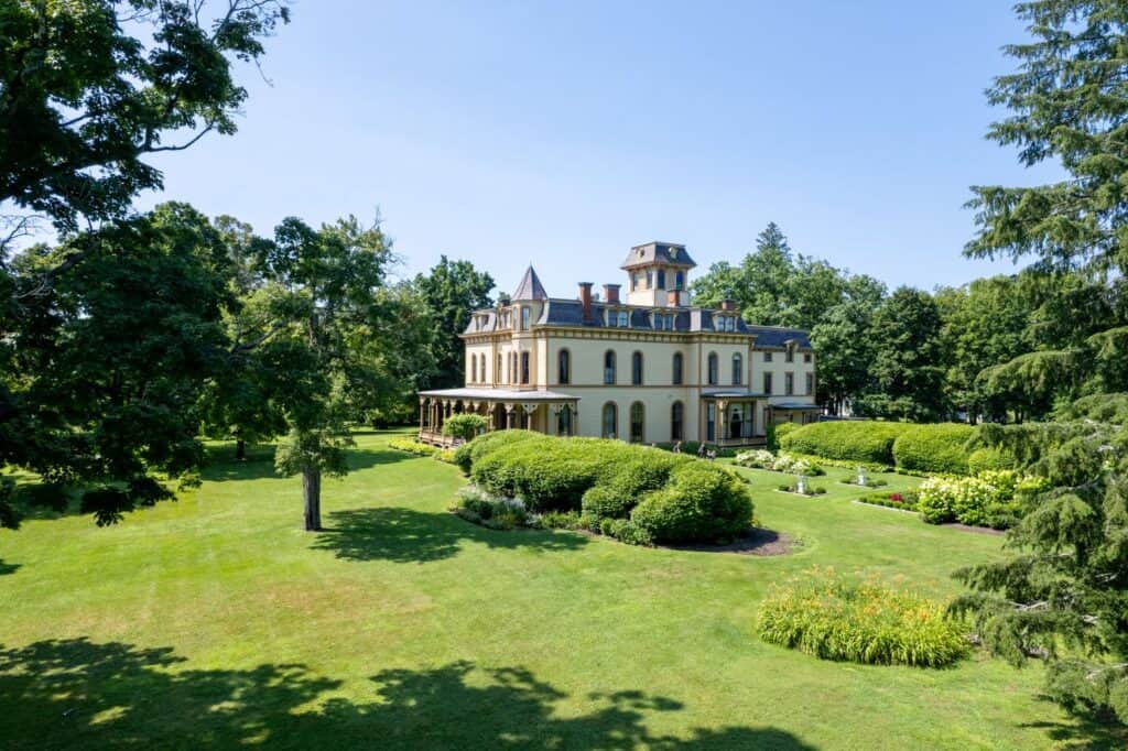Vermont Governor's Mansion surrounded by lush gardens and trees.