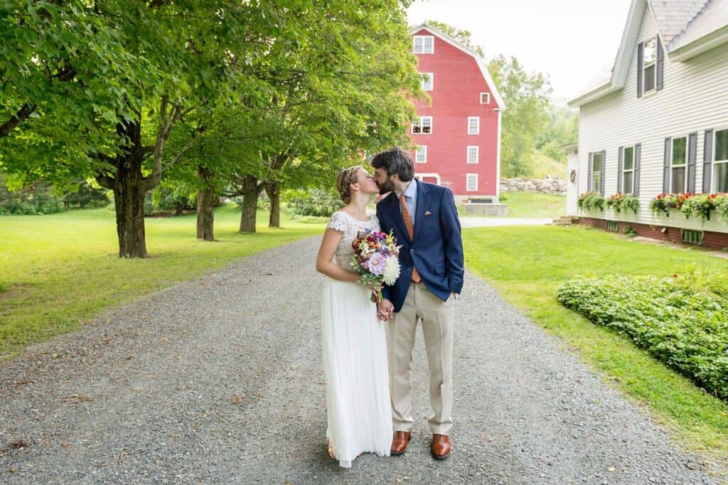 Bride and groom kissing outdoors at Robinson Farm in Vermont.