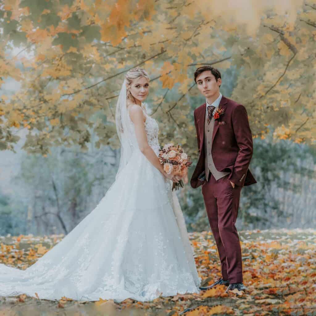 Bride and groom in autumn forest for Vermont wedding photography.