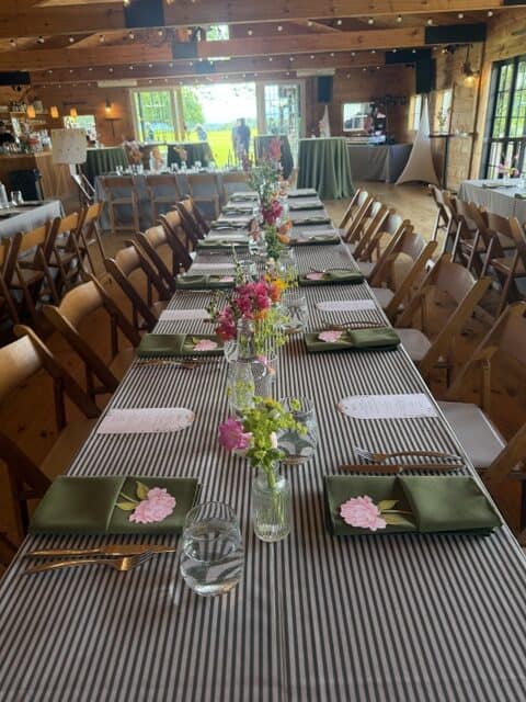 Elegant wedding reception table with floral centerpieces in Vermont.