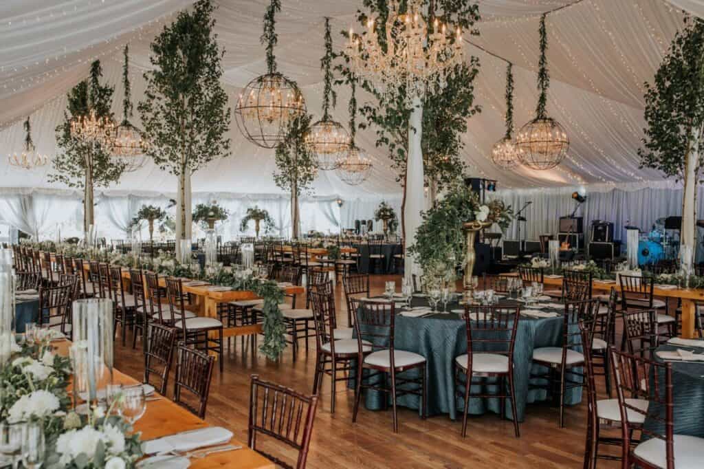 Beautiful wedding reception with elegant decor, greenery, and chandeliers at Topnotch Resort.
