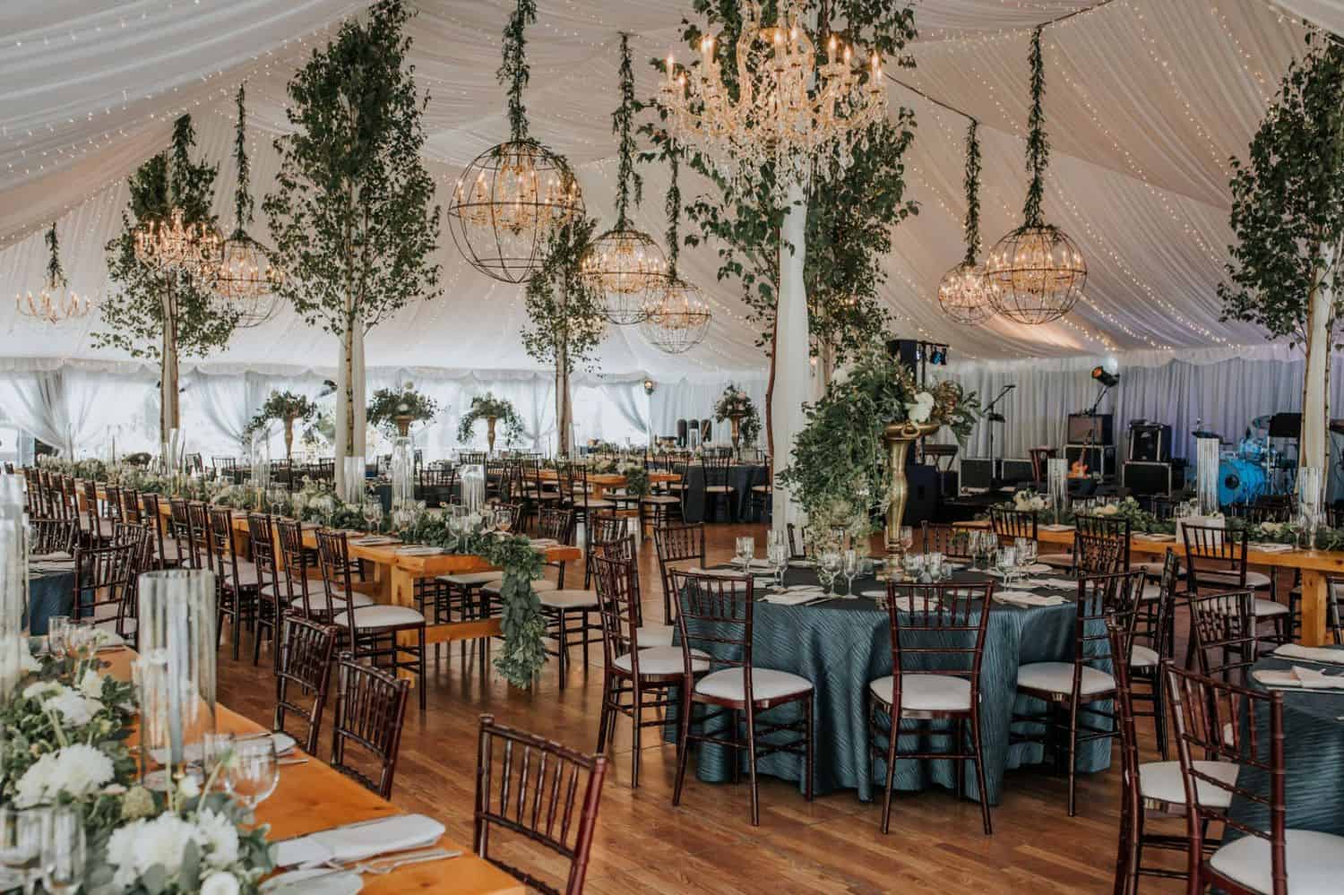 Beautiful wedding reception with elegant decor, greenery, and chandeliers at Topnotch Resort.